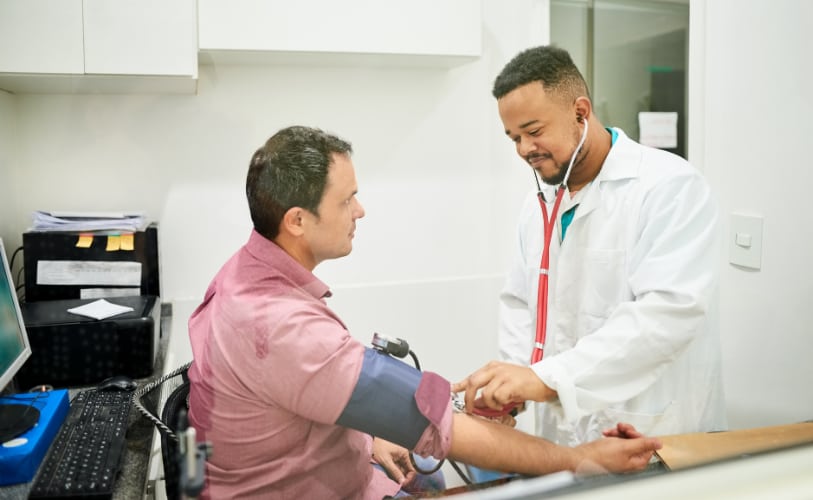 Clinician checking a patient’s blood pressure