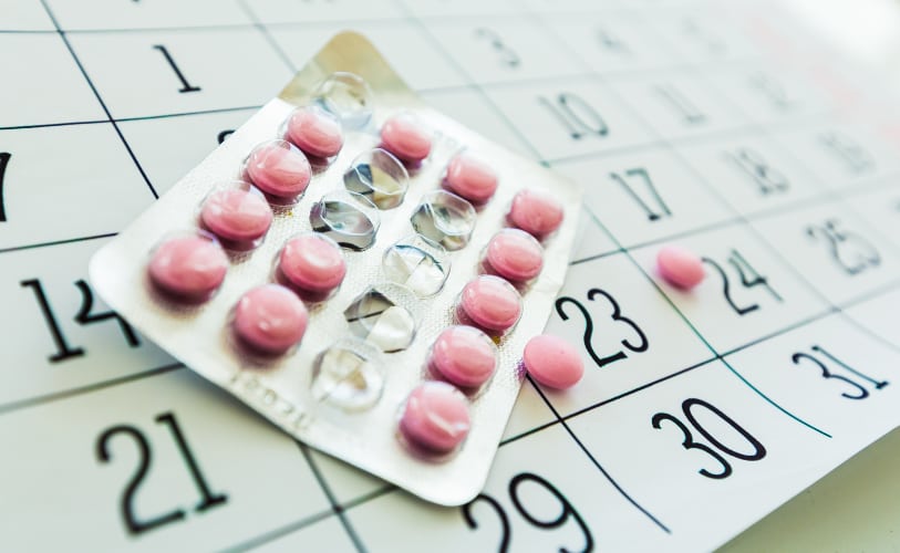 Medication blister packs on a calendar